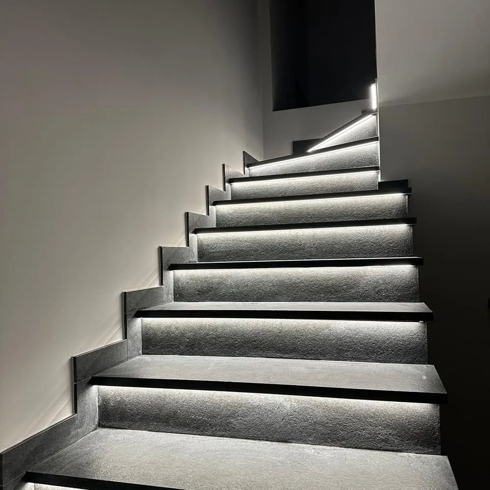 Dark stone staircase with LED lighting beneath each step
