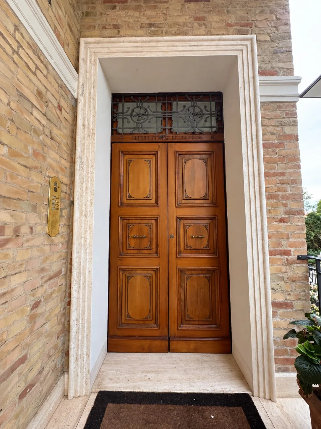 Travertine portal cut from a single block, with wooden door