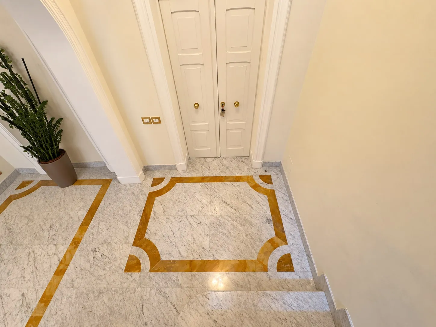 Entrance with Bianco Carrara floor and Giallo Siena inlays