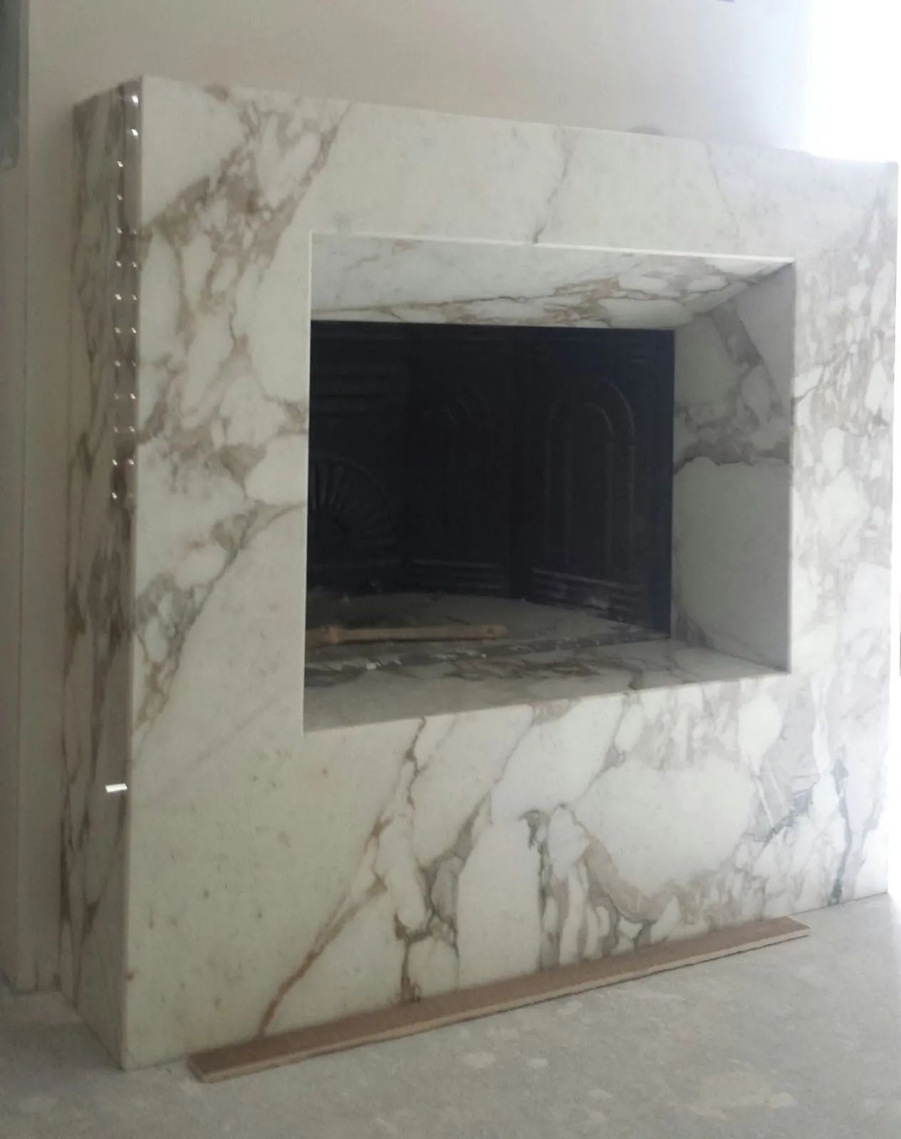 Veined white marble fireplace, front view